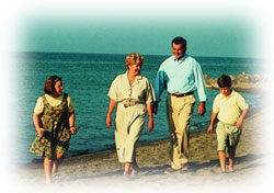 Tom Ridge and Family hike along the beach at Presque Isle